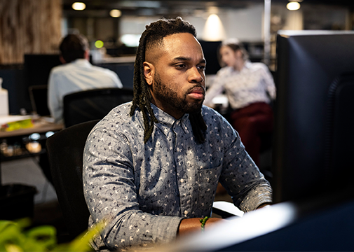 film studio accountant working in production office at a computer