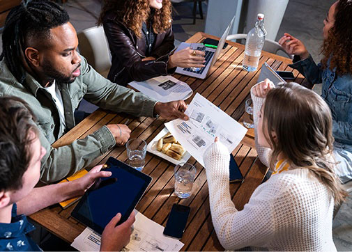 Production accountants discussing film production management and television payroll around a table