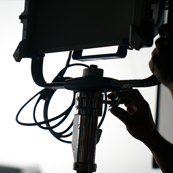 production crew adjusts lighting on set