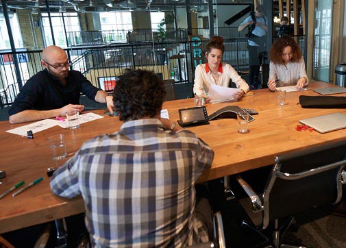  entertainment industry payroll production accountants in a conference room with a studio executive