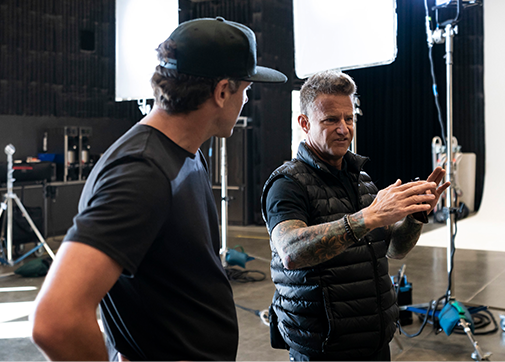 Two crew members on set having a discussion