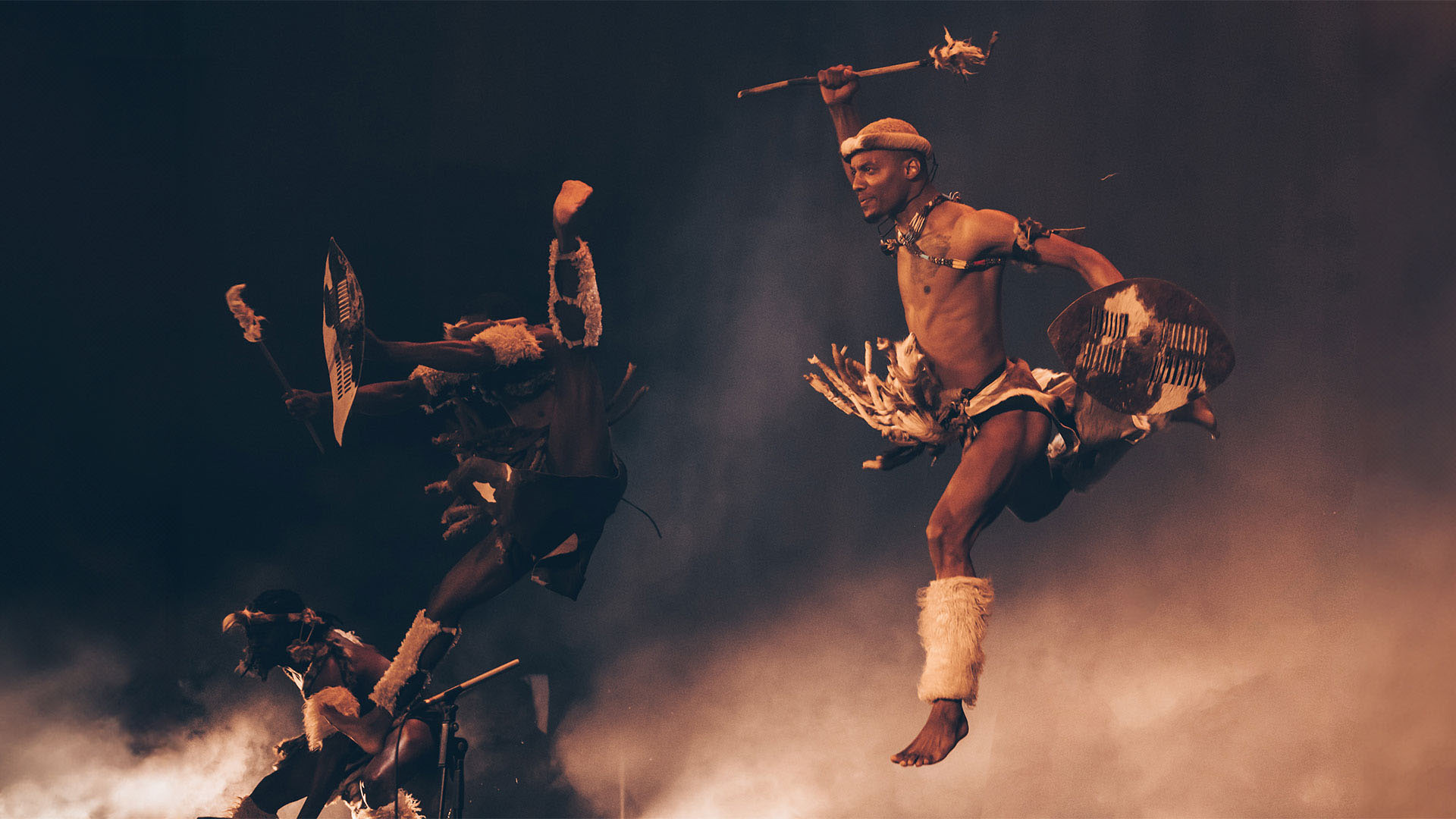 Step Afrika! dancers jumping on stage. 