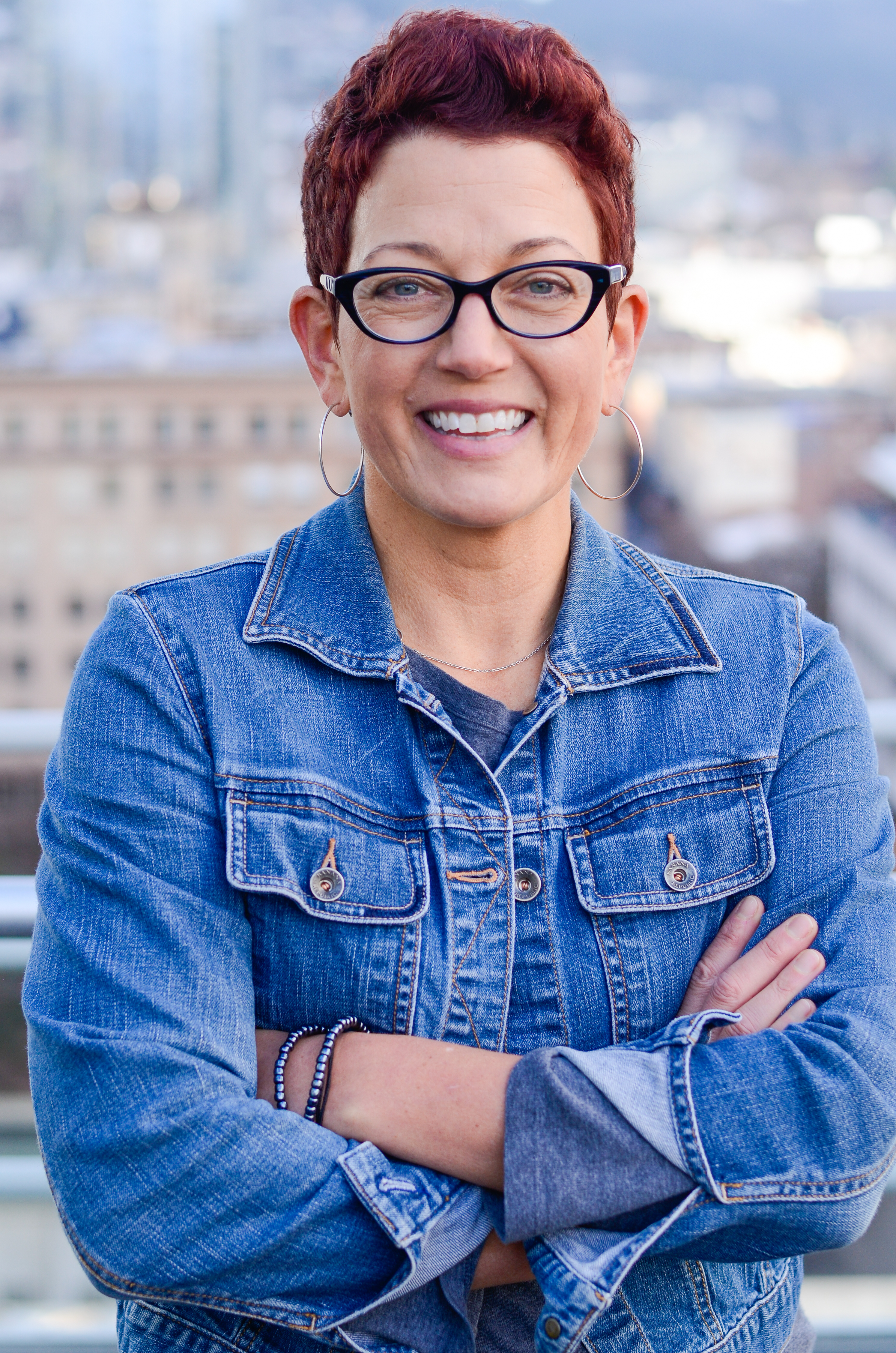 Pam Mahon posing in front of a cityscape. 