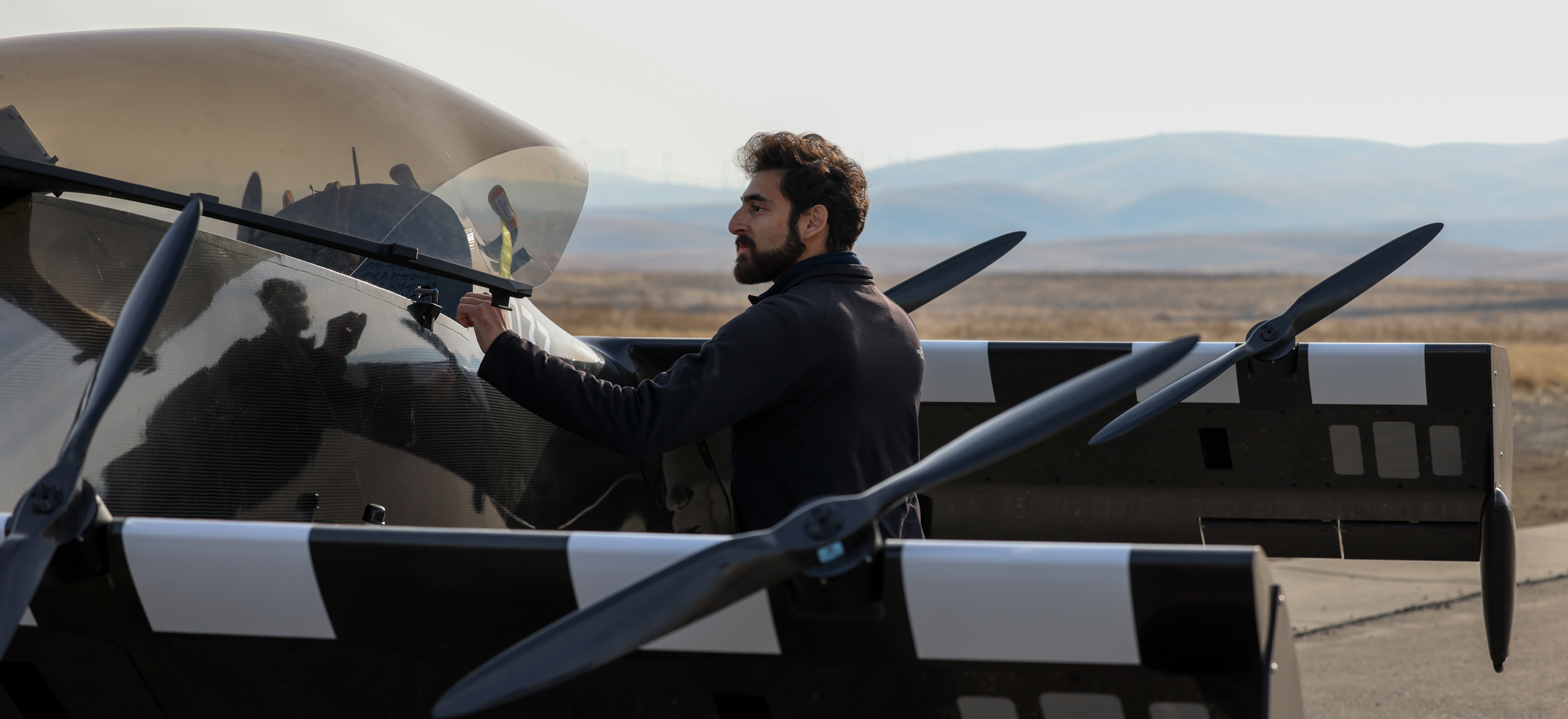 Pivotal pilot and engineer Adam Hacker does pre-flight checks on an aircraft