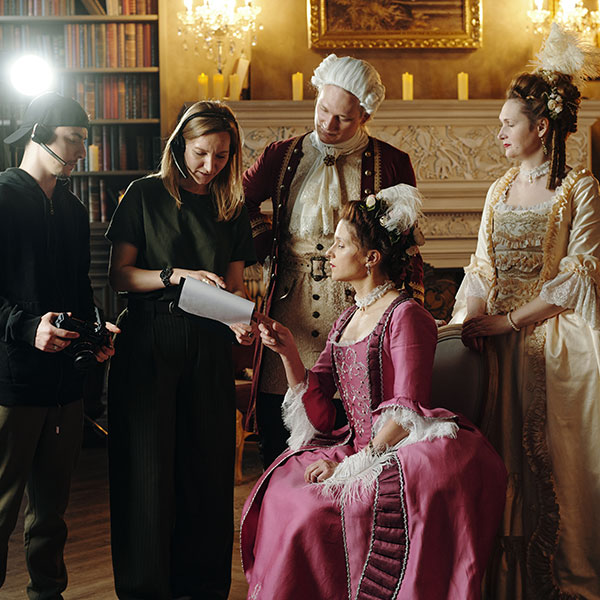 Background actors with crew on film set