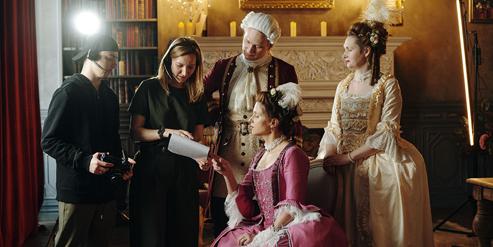 Background actors with crew on film set