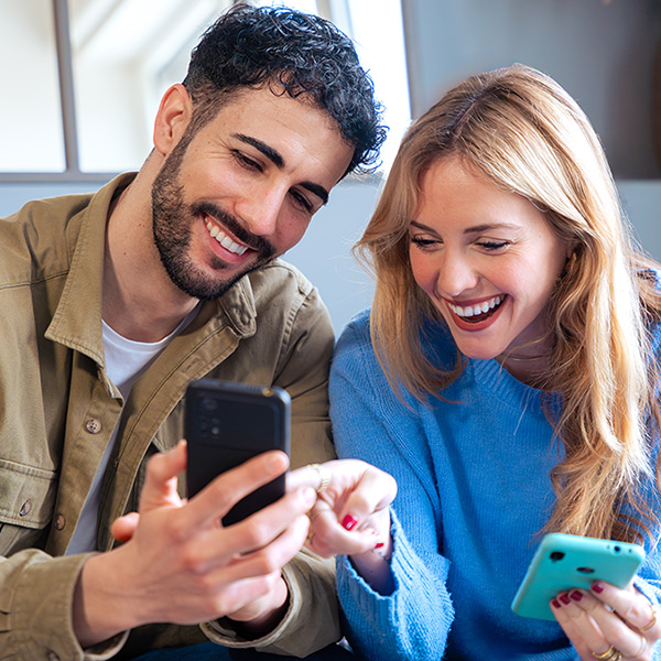 A man and woman looking at a cell phone