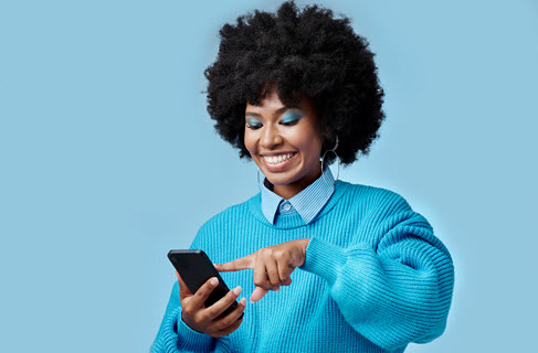 Happy person in blue sweater tapping phone