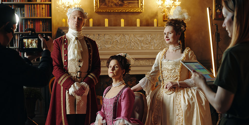 Actors on a movie set with Victorian era production design