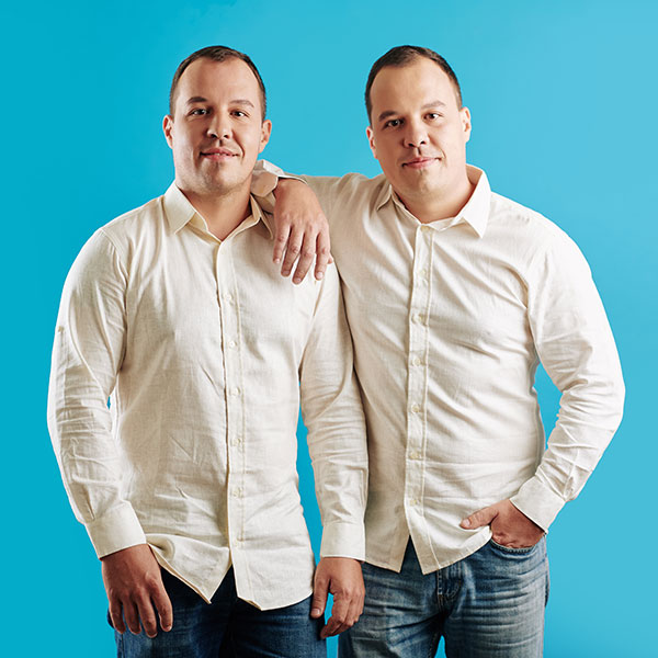 A male photo double standing next to an identical looking actor
