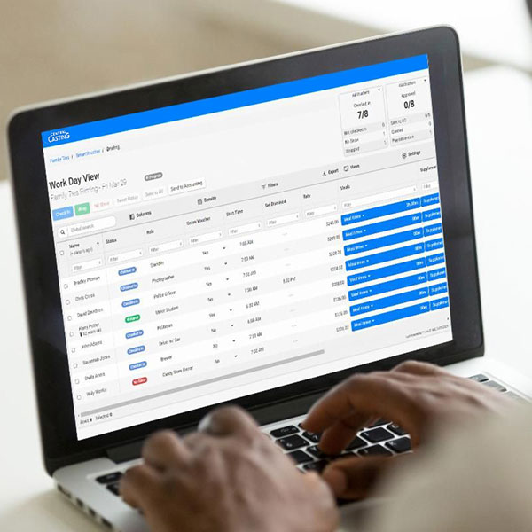 An assistant director using digital background voucher SmartVoucher on a laptop