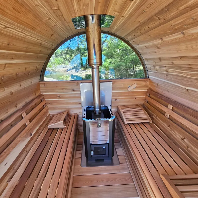 Interior of a LeisureCraft barrel sauna showing curved cedar walls and bench layout
