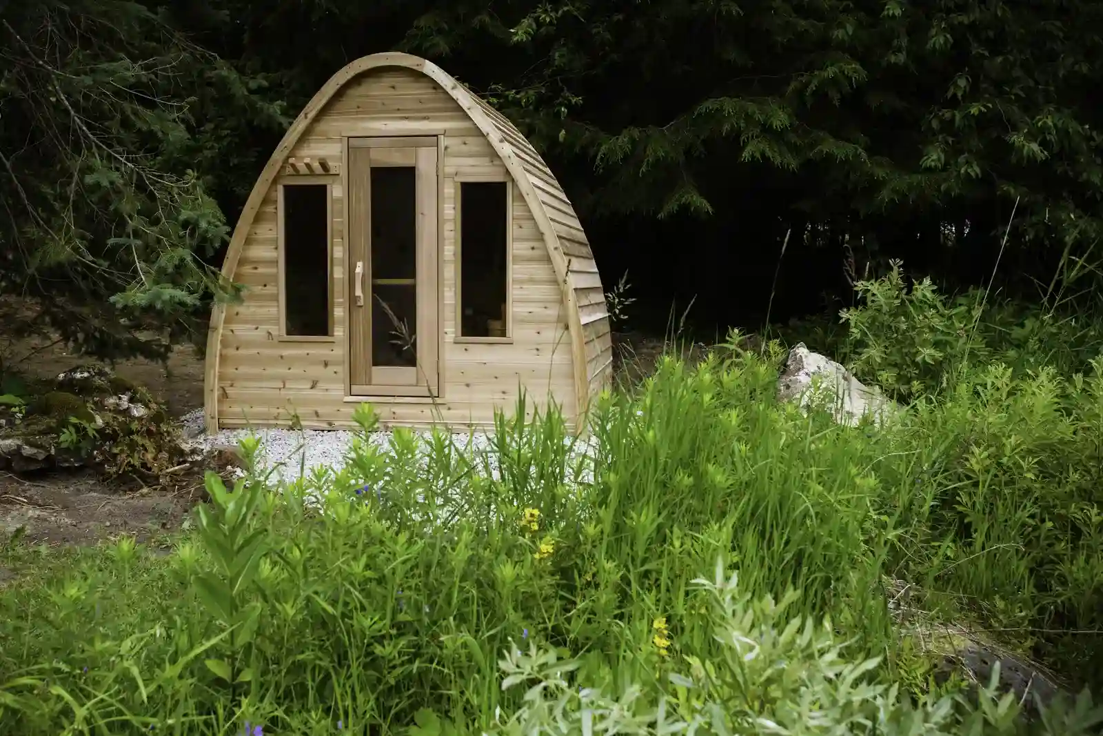 LeisureCraft POD sauna with its tear-drop cedar profile, set on a gravel base