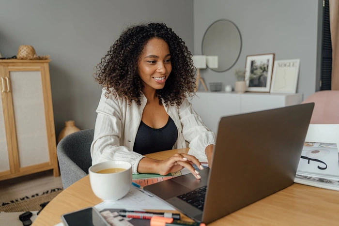 A woman sits at her computer