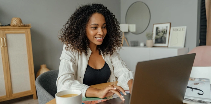 A woman sits at her computer