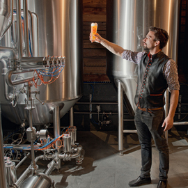 Man with beer in brewery