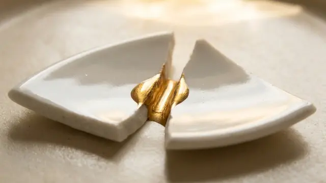 Kintsugi gold repair on broken pottery representing couples therapy, conflict resolution strategies, and healing a relationship after a horrible fight.