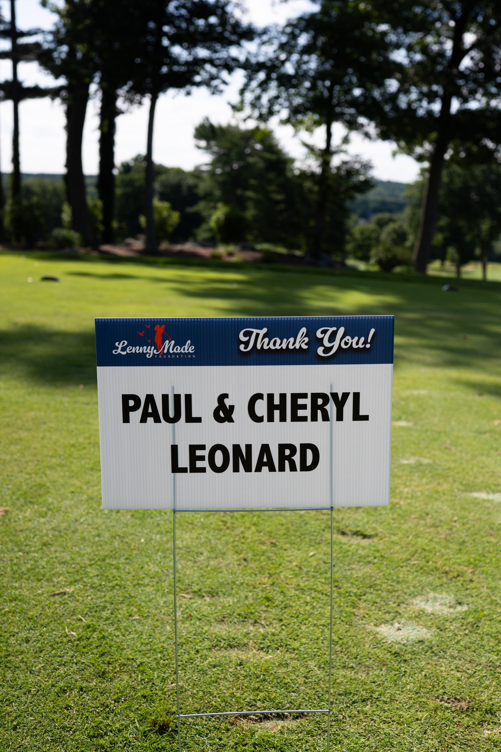 A LennyMade Foundation Thank You sponsor sign for Paul and Cheryl Leonard staked in the grass.