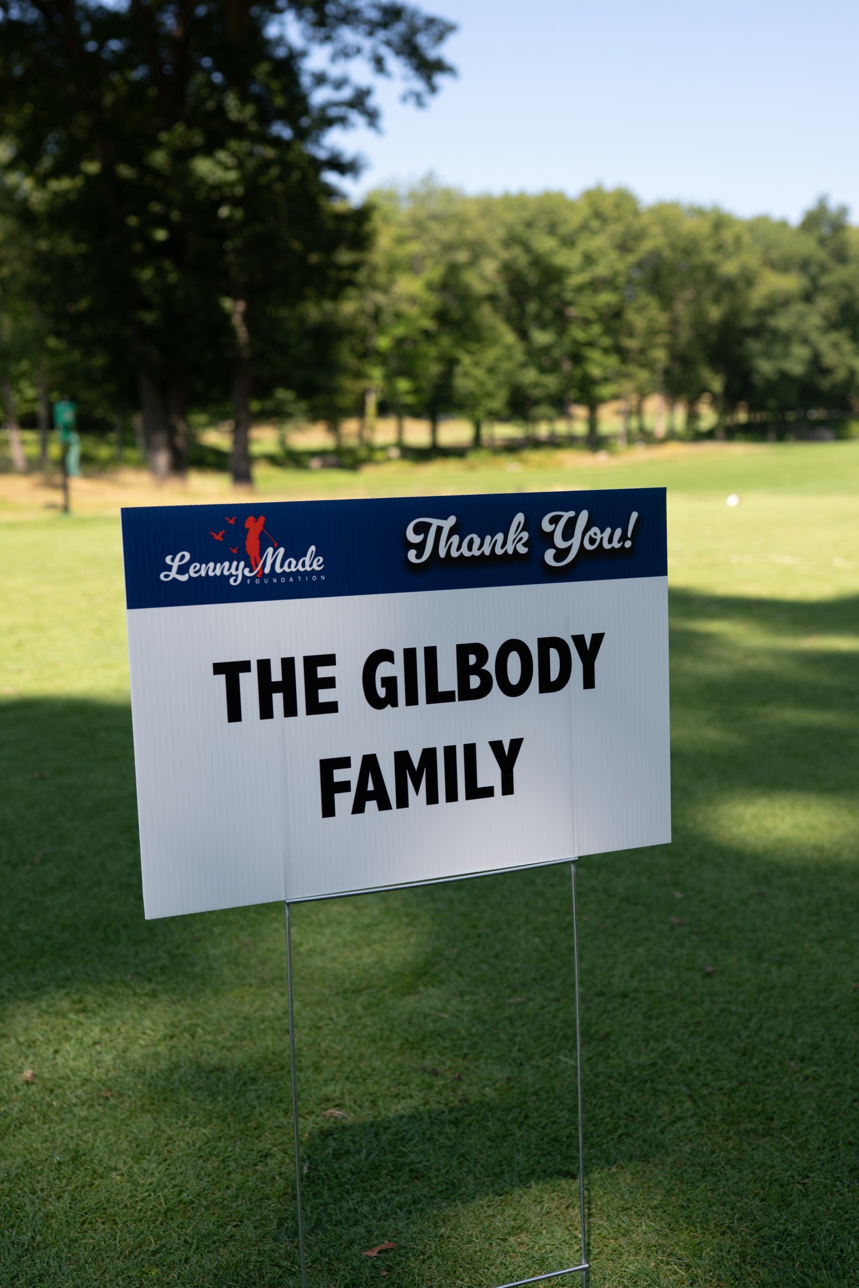 A LennyMade Foundation Thank You sponsor sign for The Gilbody Family staked in the grass.