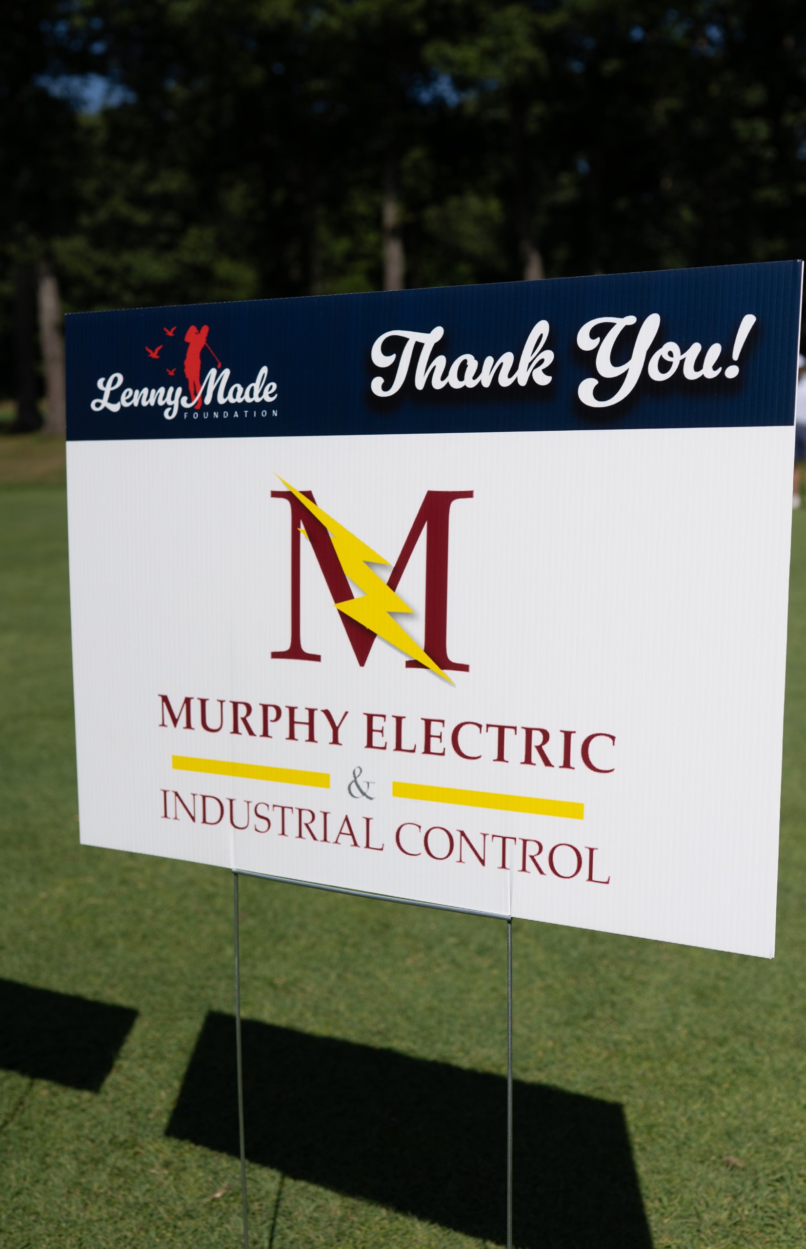 Close-up of the LennyMade Foundation Thank You sponsor sign for Murphy Electric and Industrial Control.