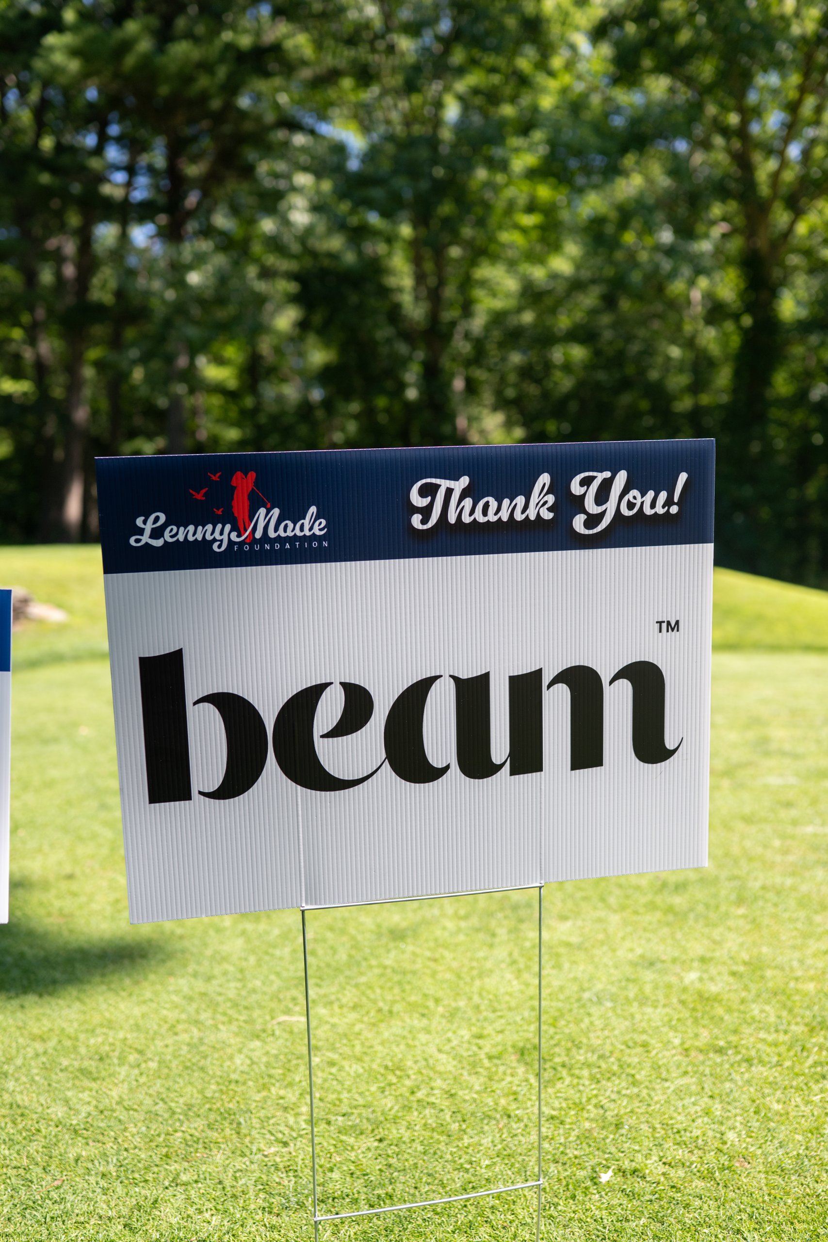 A LennyMade Foundation Thank You sponsor sign for Beam staked on the grass.