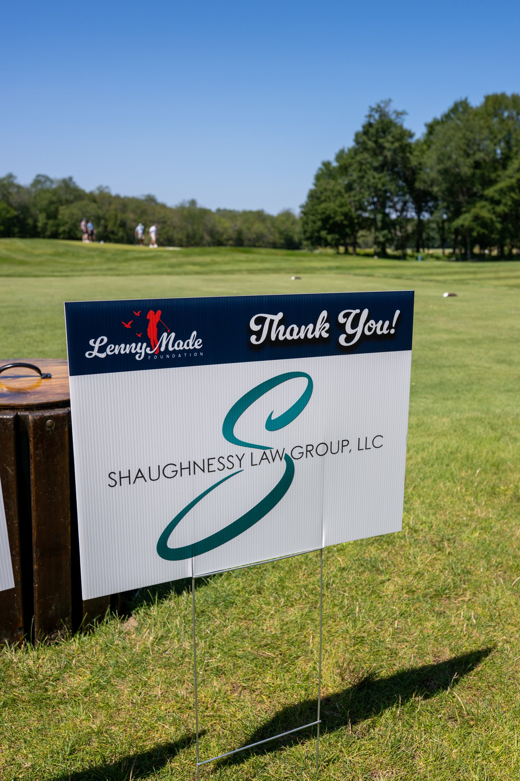 A LennyMade Foundation Thank You sponsor sign for Shaughnessy Law Group, LLC on the course.
