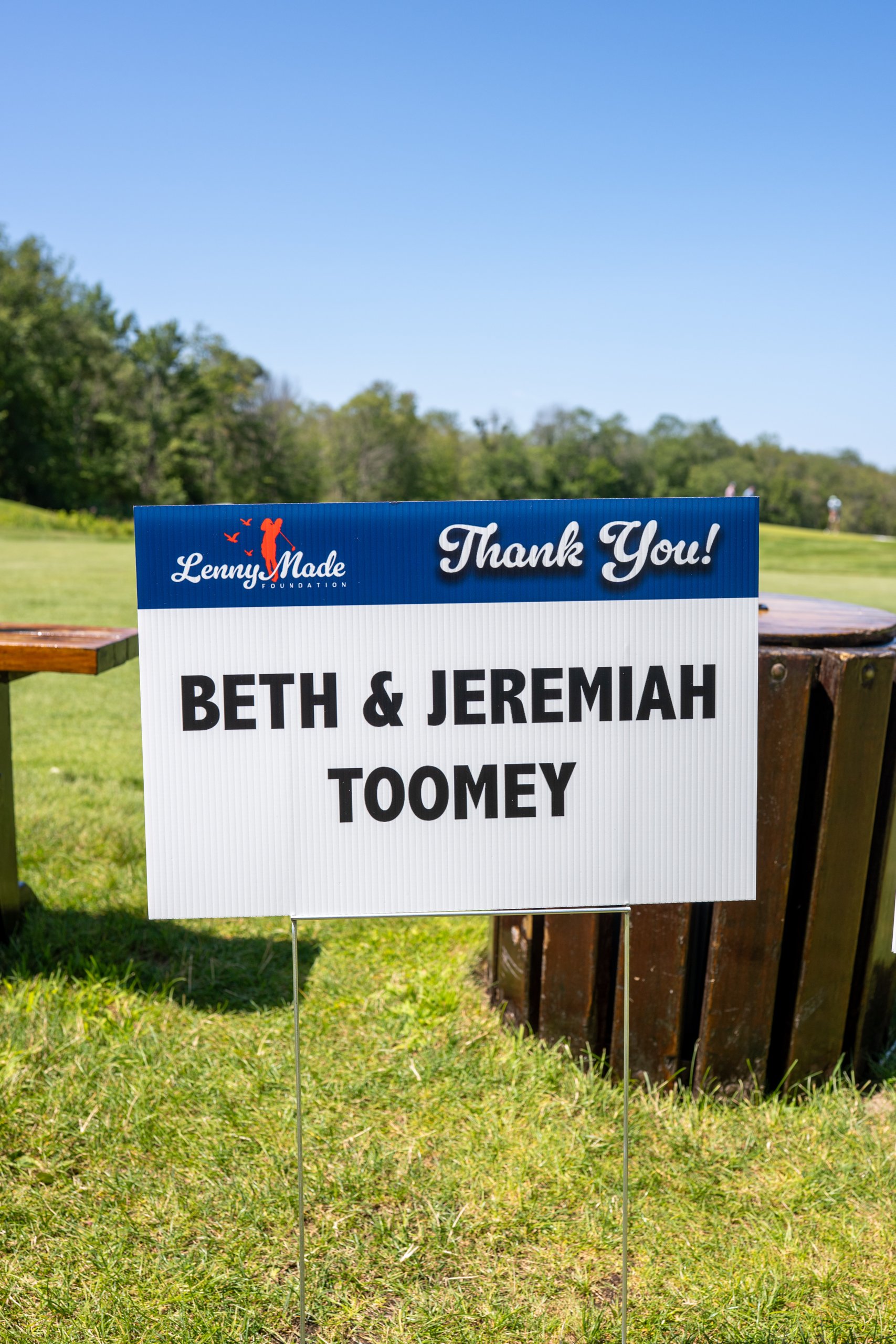 A LennyMade Foundation Thank You sponsor sign for Beth and Jeremiah Toomey at a tee box.