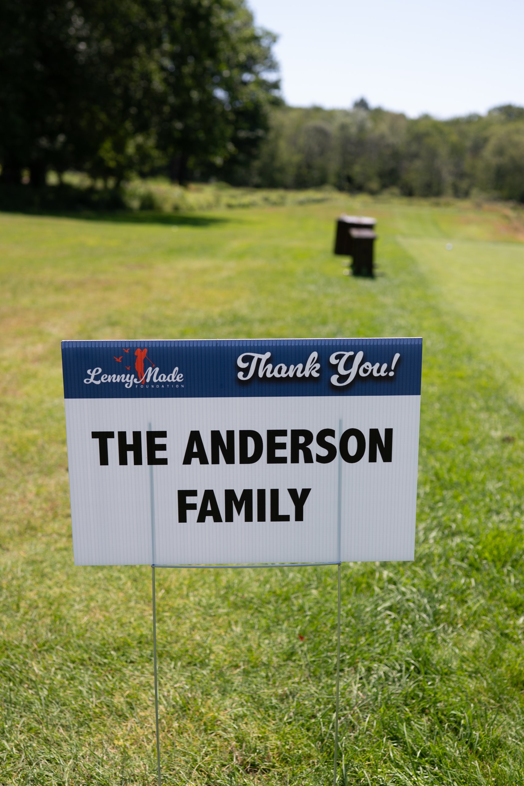 A LennyMade Foundation Thank You sponsor sign for The Anderson Family at a tee box.