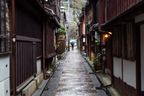 A neat little alleyway. The little potted plants add a nice touch next to the gutters.