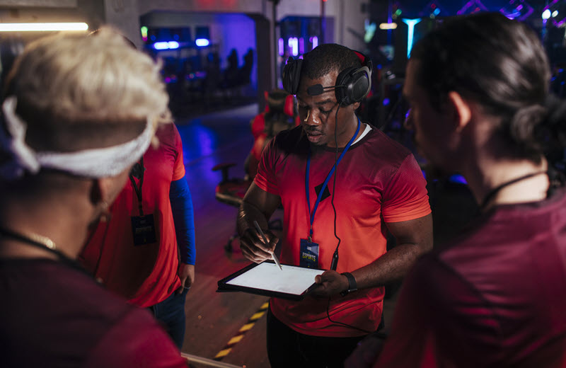 Production crew member checking in a supporting artist on set.