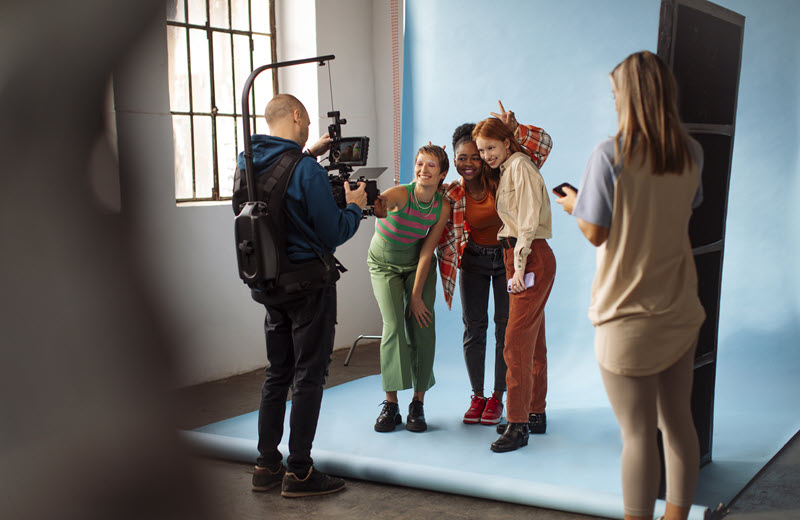 Supporting artists filming a scene on a UK production set.