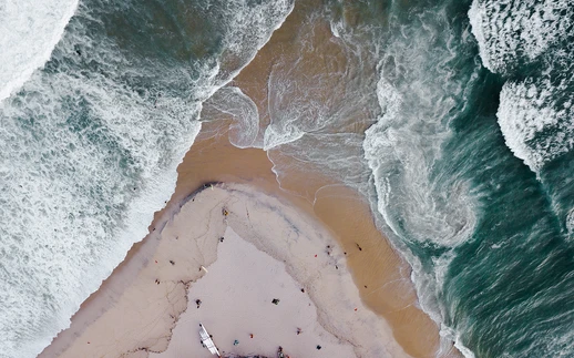 aerial-drone-shot-of-beach-by-tanner-thibert.webp