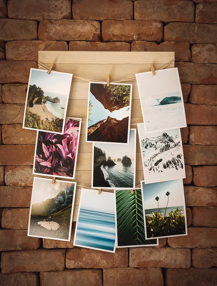 collection-of-prints-hanging-on-brick-wall.jpg