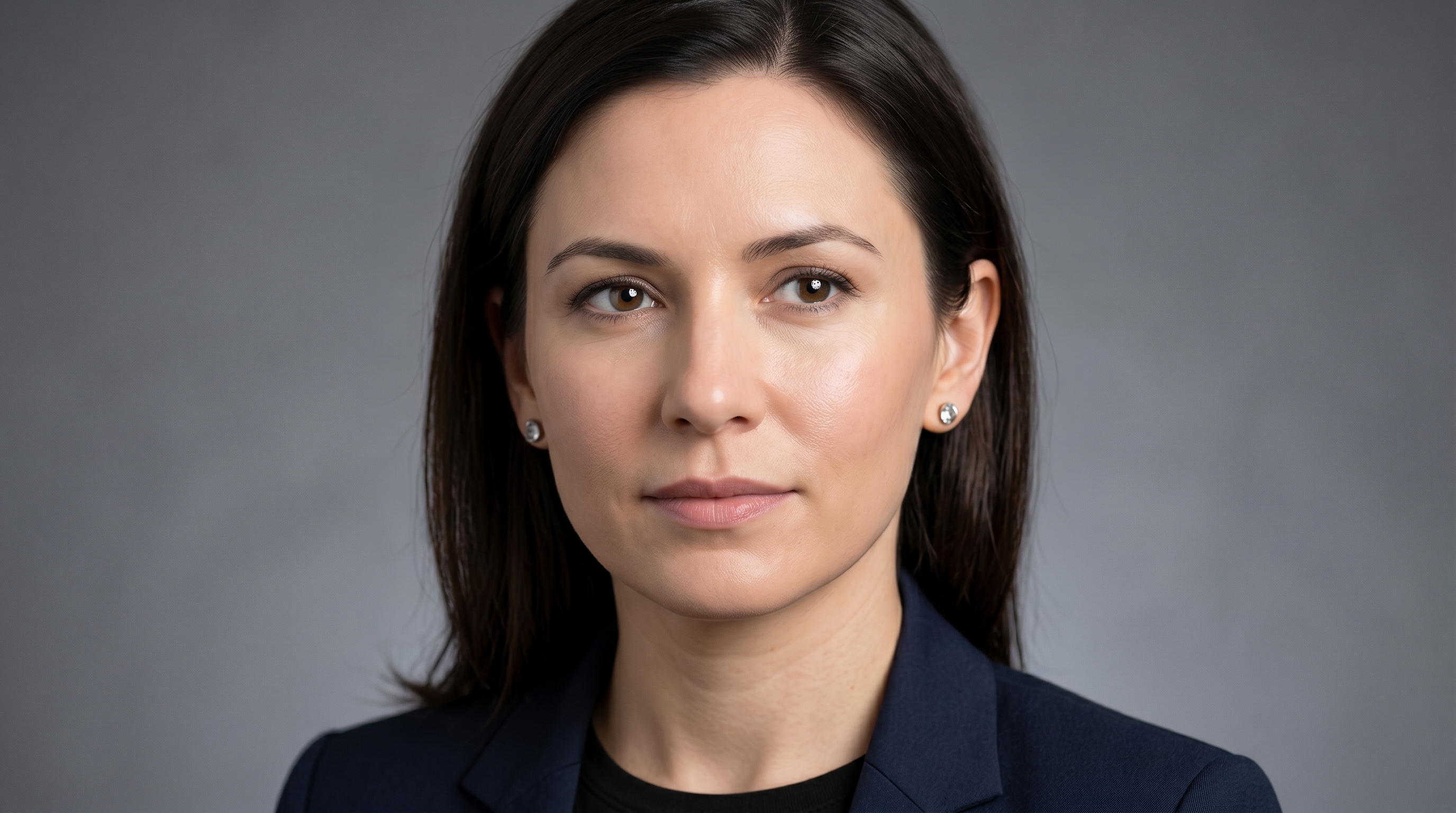 Close-up of an AI-generated headshot showing common artifacts including mismatched eye reflections, overly smooth skin texture, blurred hairline edges, and distorted earring rendering
