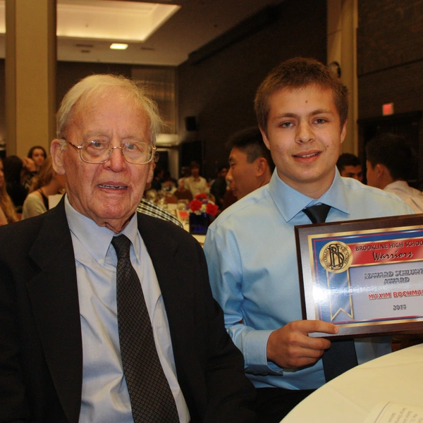 Student Athlete holding an award