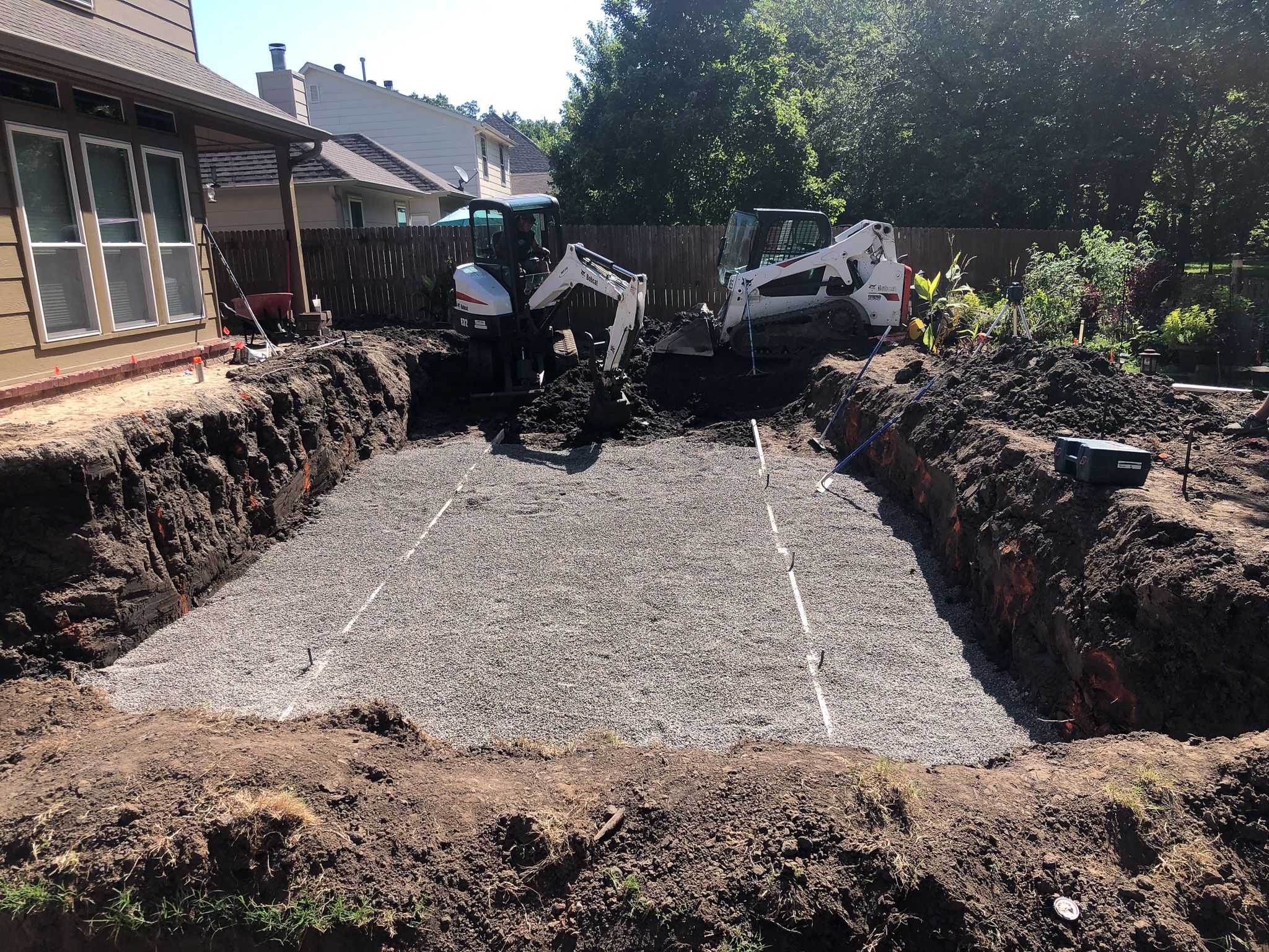 3/8 chip stone base for fiberglass pool installation in a Tulsa backyard.
