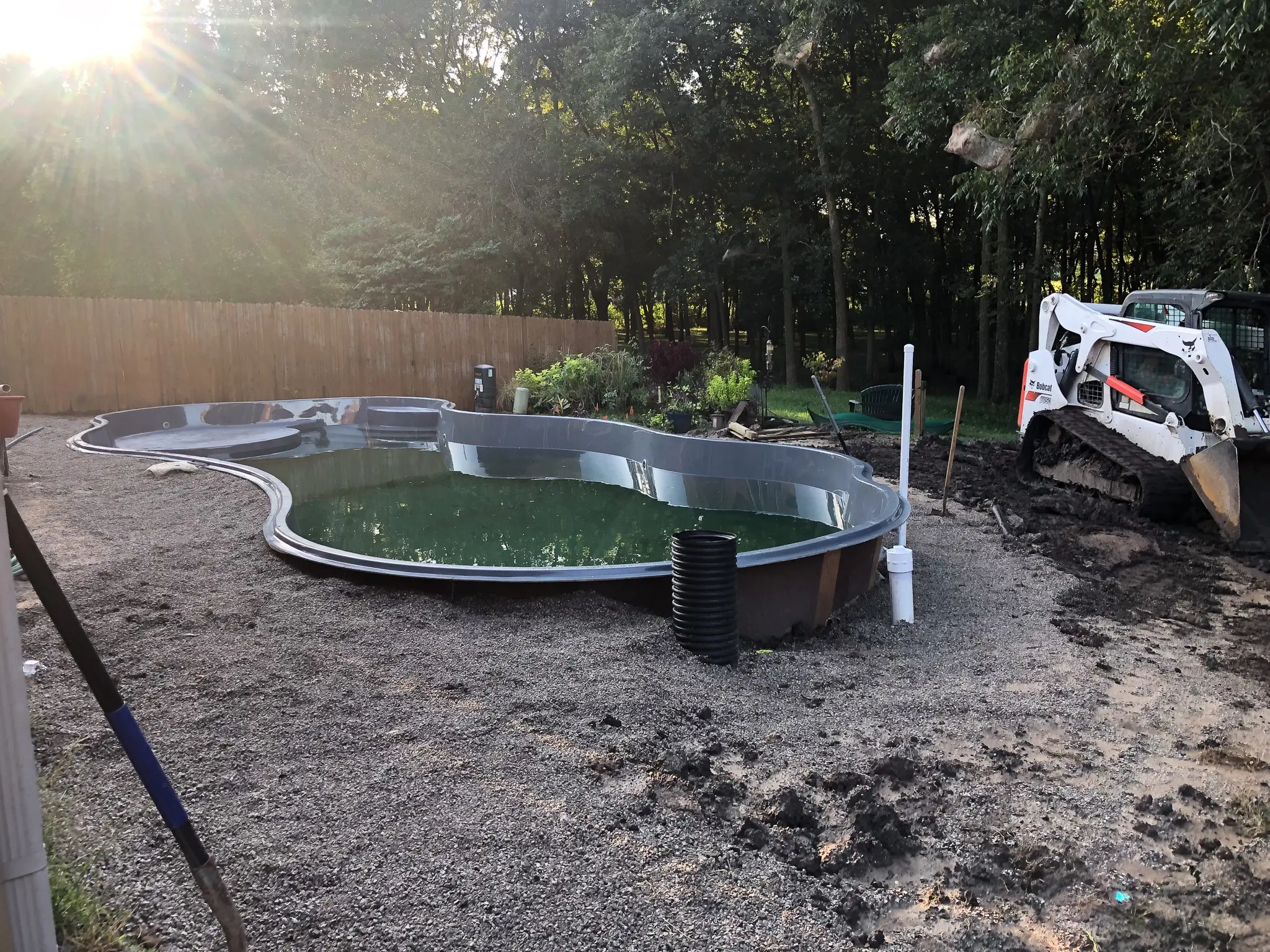 Fiberglass pool with 3/8 chip stone backfill.