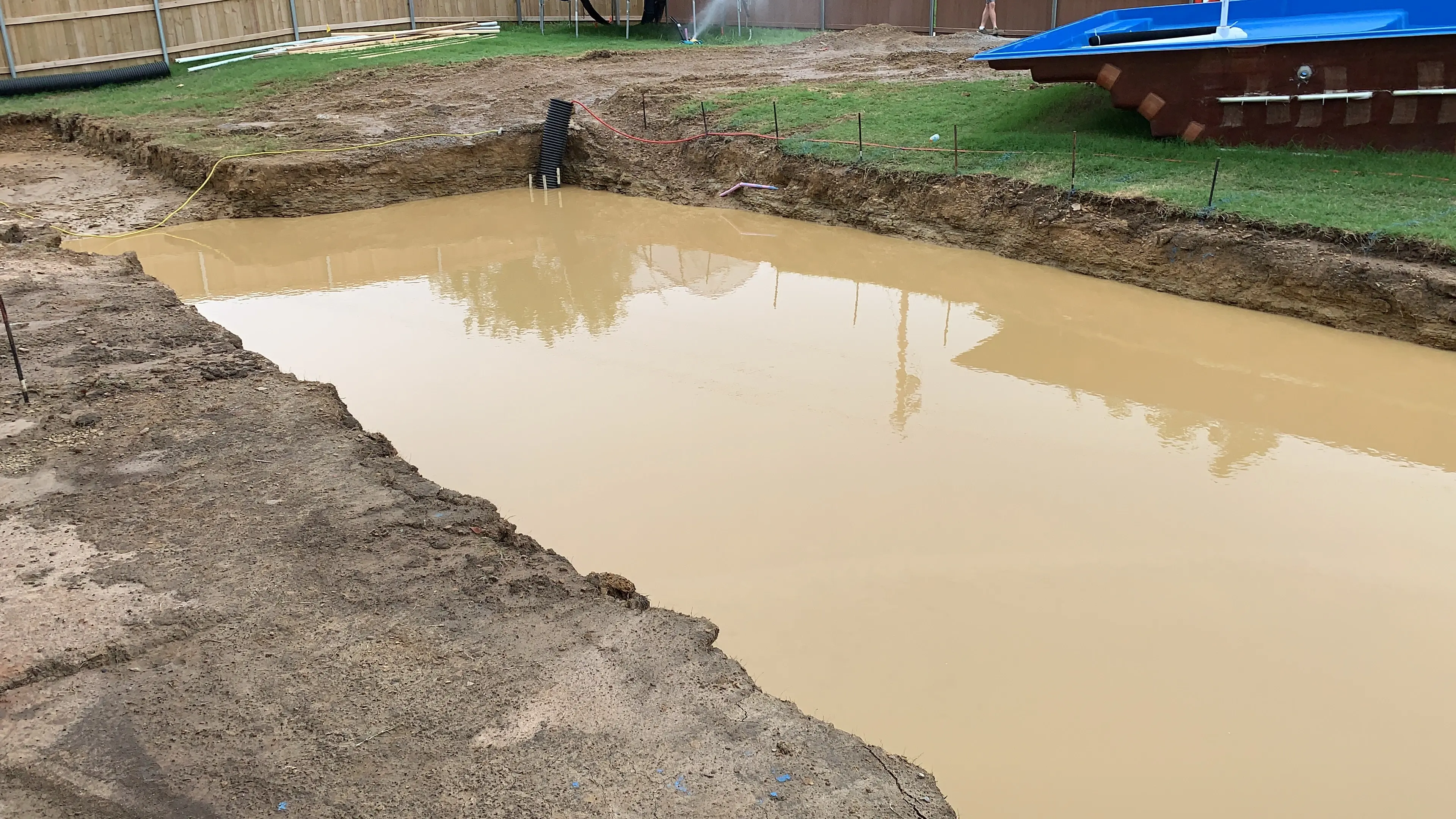 Rain flooded the hole during a fiberglass pool build in Tulsa.