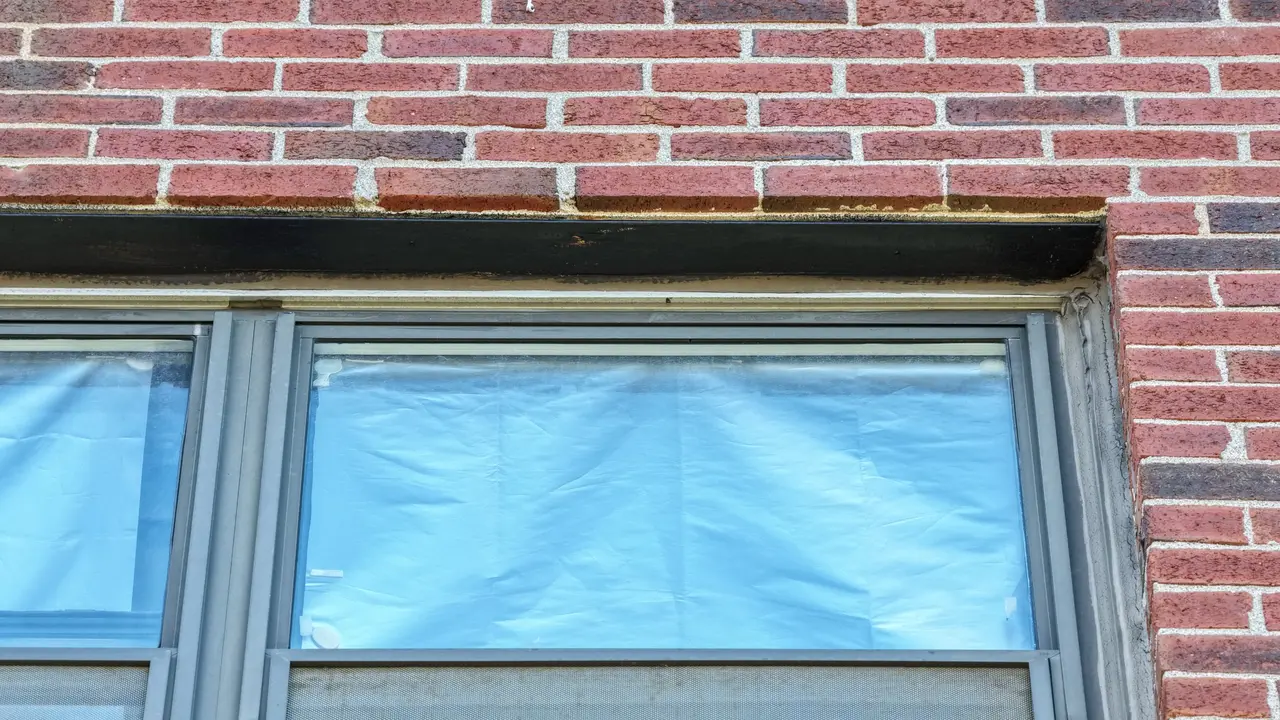 Close-up of a steel window lintel above a window on the Rindge Towers facade after lead remediation.