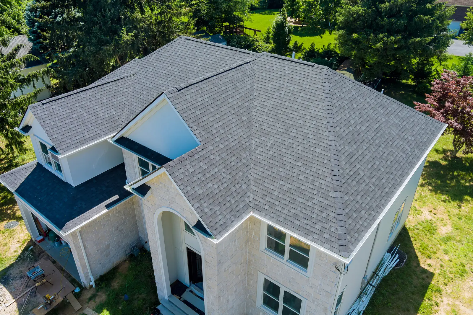 Side-by-side comparison of traditional ladder roof inspection vs drone roof inspection on a Massachusetts home