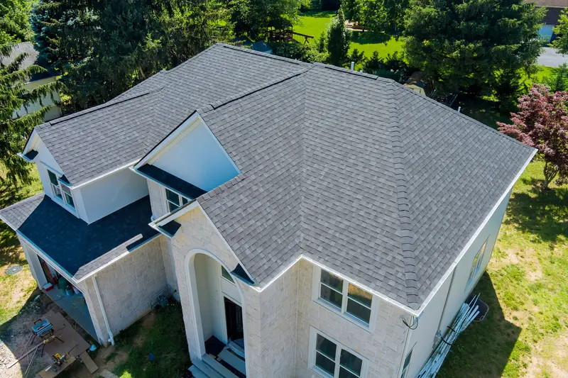 Side-by-side comparison of traditional ladder roof inspection vs drone roof inspection on a Massachusetts home