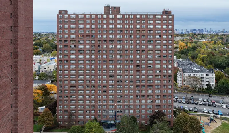 Aerial view of the 362 Rindge Avenue brick facade showing the full grid of windows and lintels.