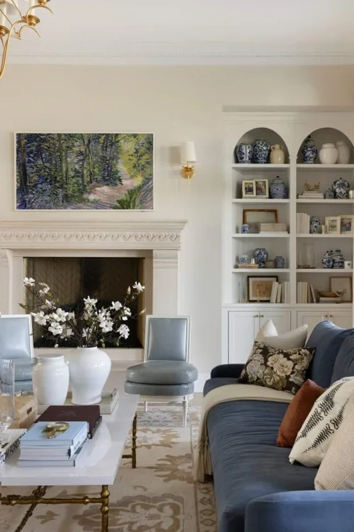 Inviting Living Room with Blue Sofas and Warm Rust Velvet Accents - Living Room interior design by Decozie