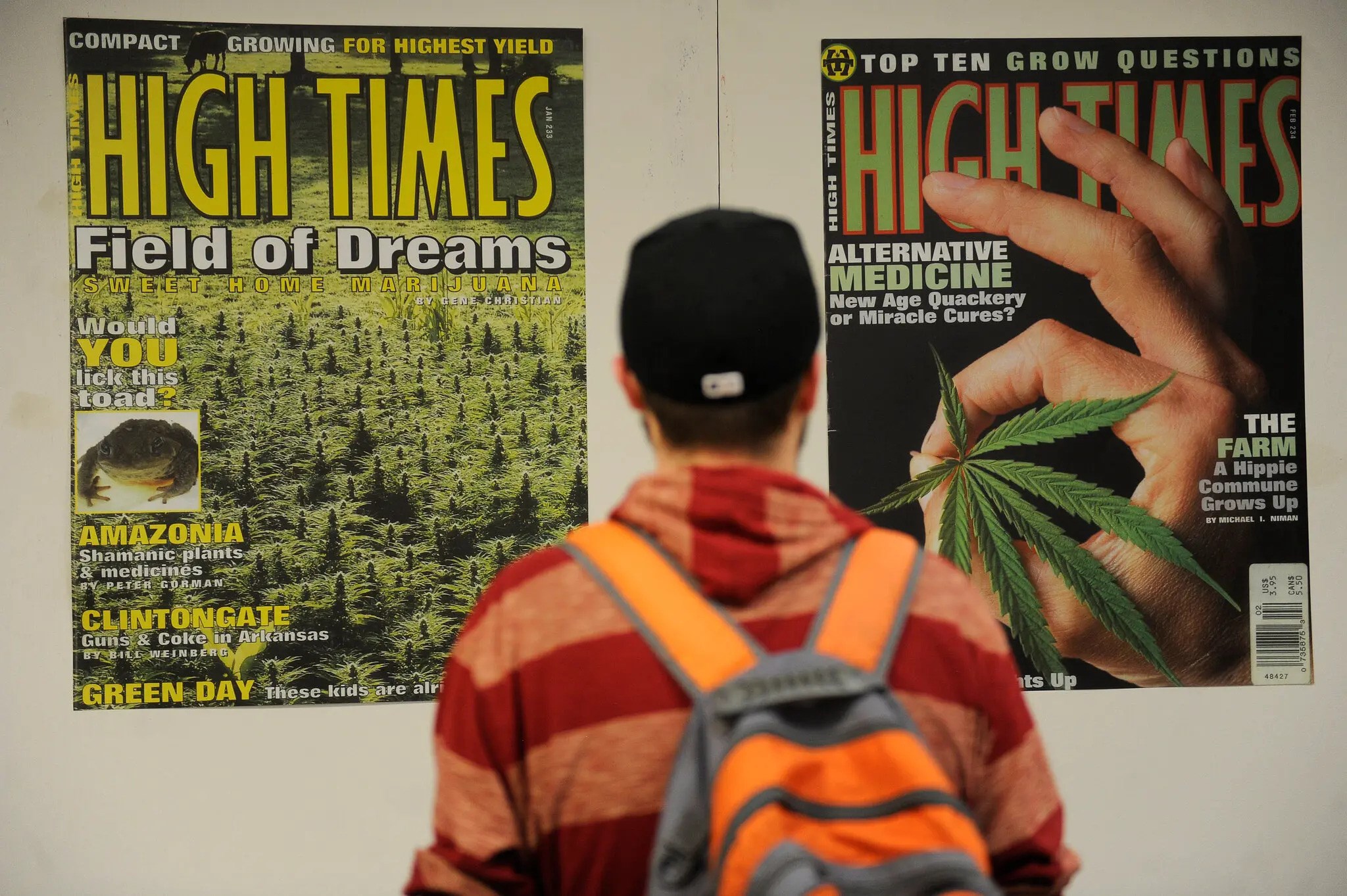 A man looks at high times covers